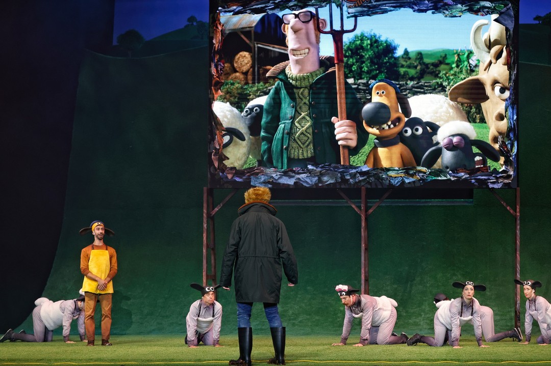 farmer on stage looking at artists dressed as sheep in shaun the sheep circus show