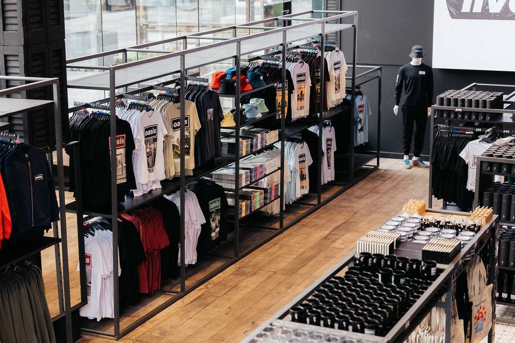 oasis fan store manchester interior shot clothes on rails playng at heaton park