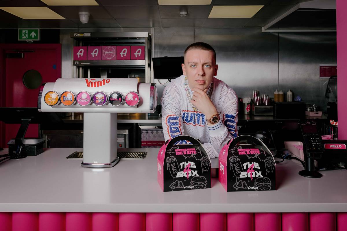 rapper Aitch at Archie's counter with The 4 Box meals in front of him