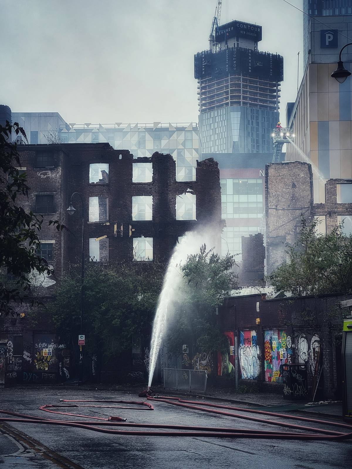 hotspur press manchester with water sprayed on building
