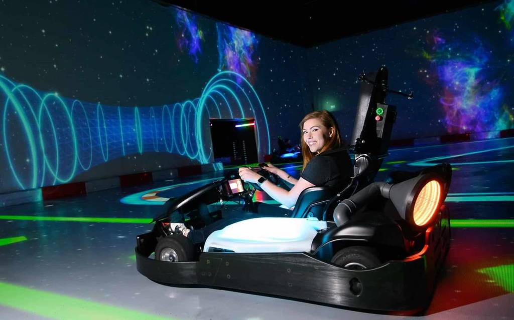 a woman in a cart at Chaos Karts