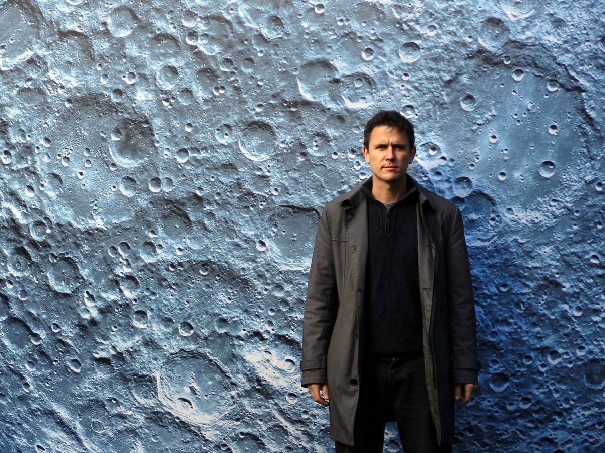 luke jerram stood next museum of the moon sculpture coming soon to alderley park near manchester