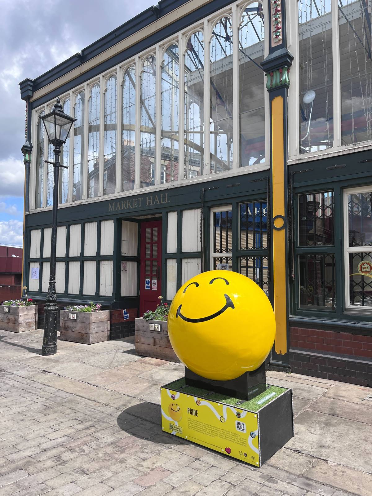 smileyworld sculpture outside stockport market hall