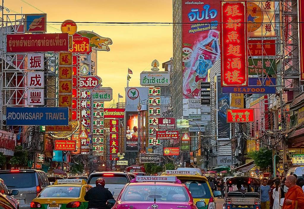 lots of cars on road i chinatown bangkok where you can fly to from manchester