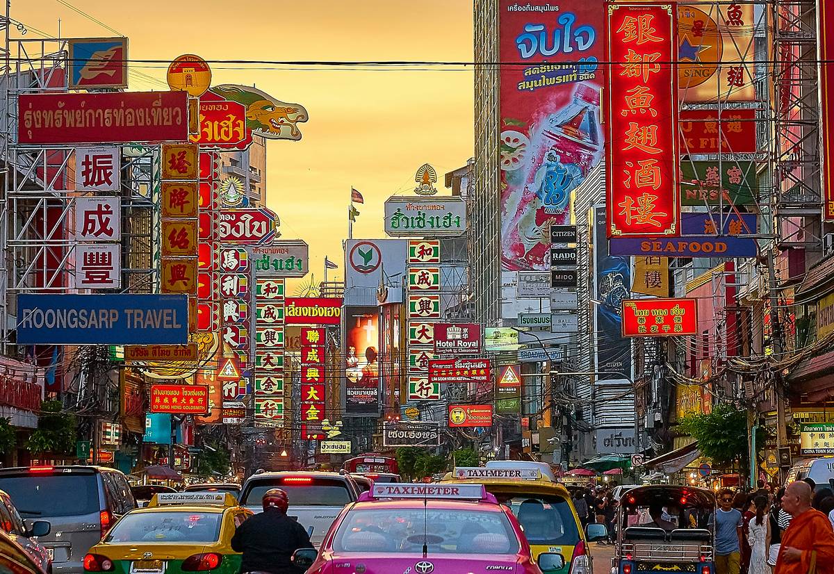 lots of cars on road i chinatown bangkok where you can fly to from manchester