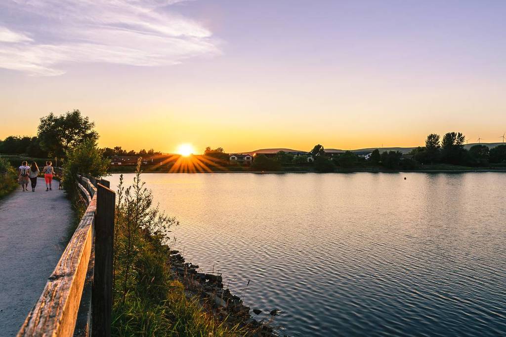 hollingworth lake sunset over water path people walking