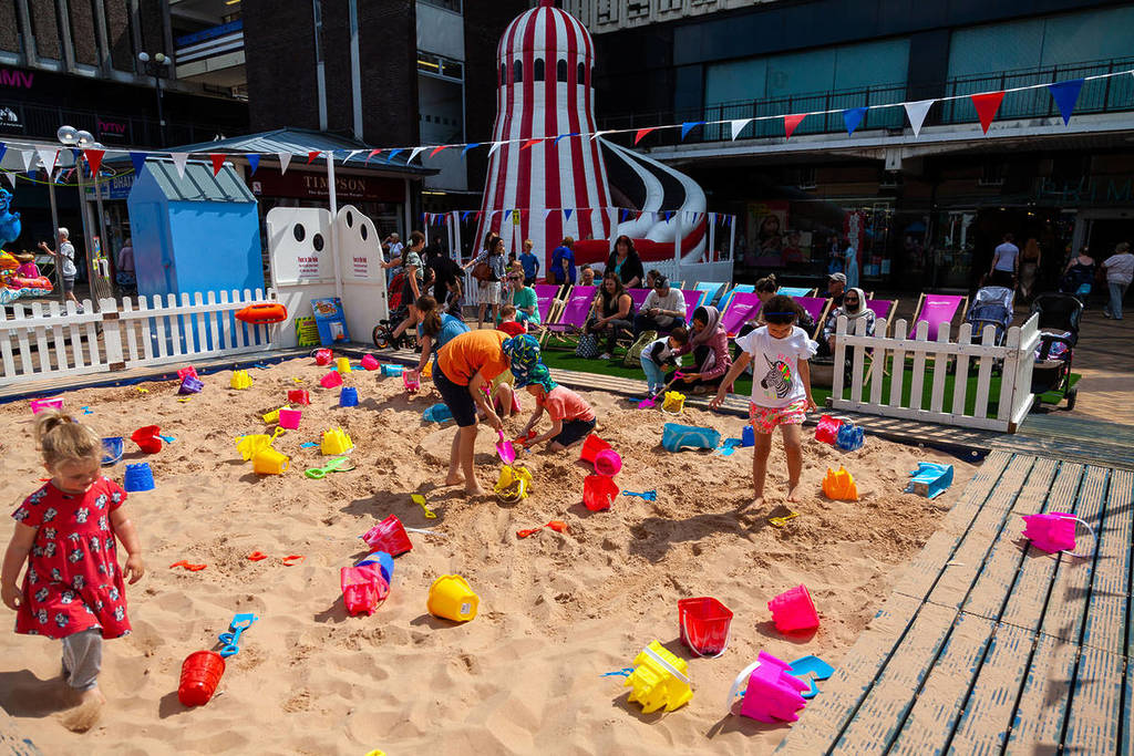 merseybay beach kids playing with buckets and spades stockport