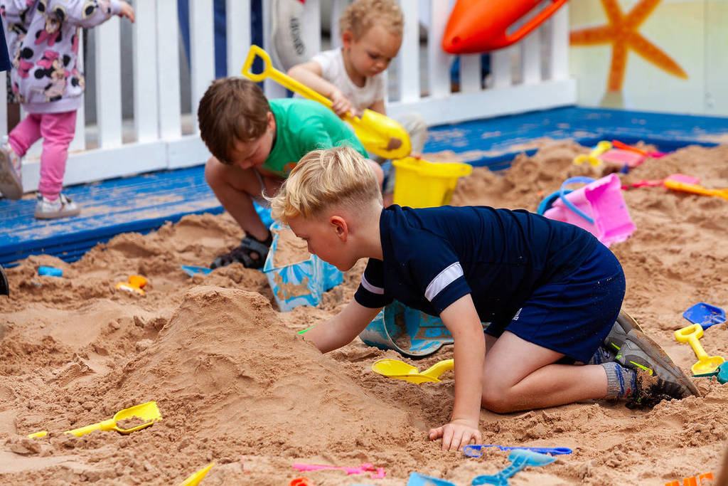 merseybay beach kids playing with buckets and spades stockport