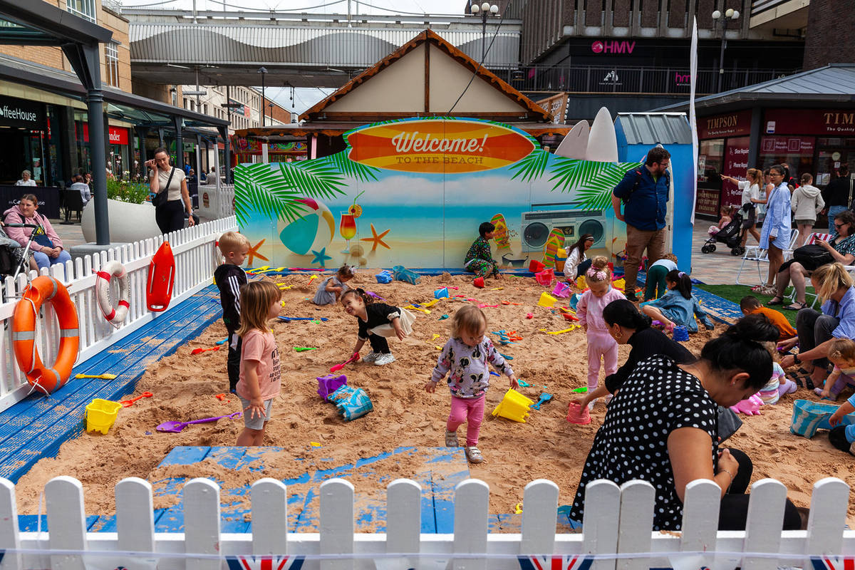 merseybay beach kids playing with buckets and spades stockport