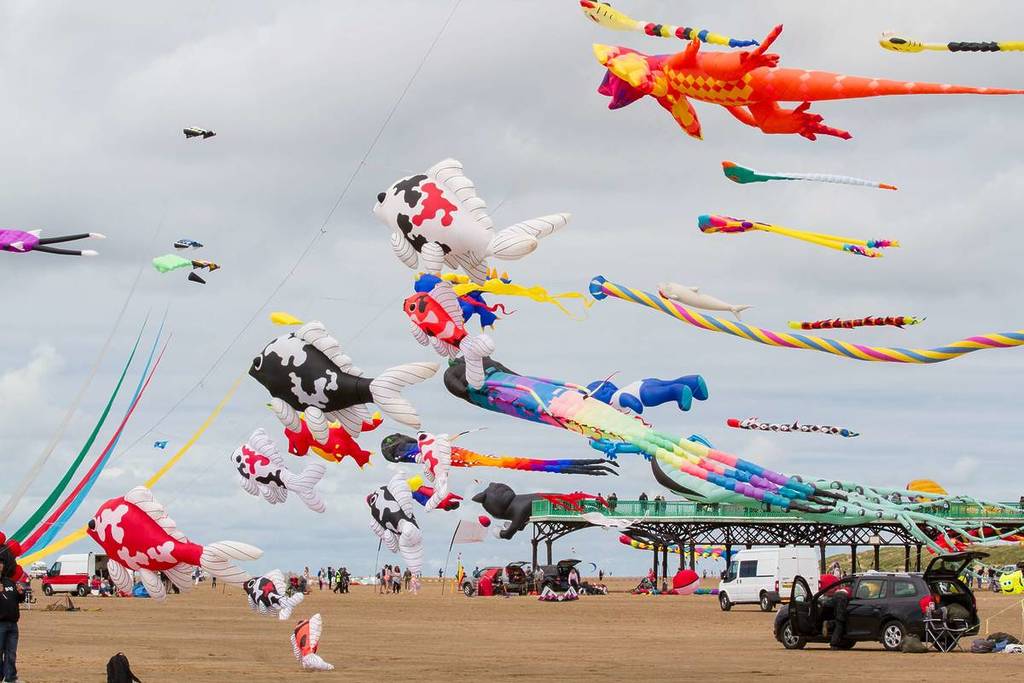 fish shaped kites being flown on st annes beach