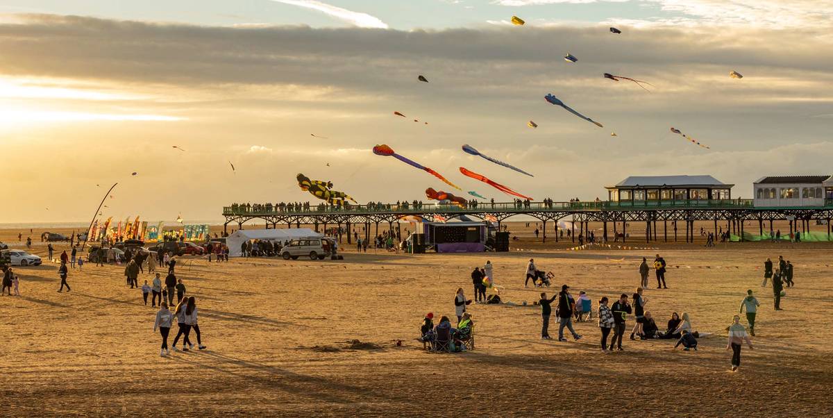 st annes beach with kite flying and pier in background
