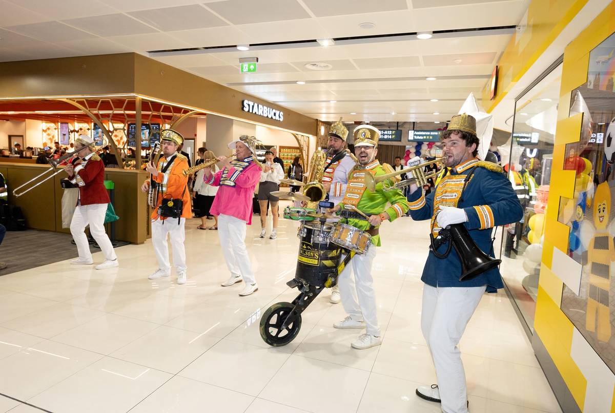 manchester airport terminal 2 partly open lounge brass band in front of starbucks