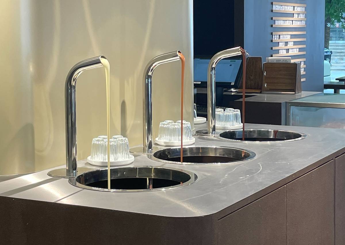 three taps with white, milk and dark chocolate running from each