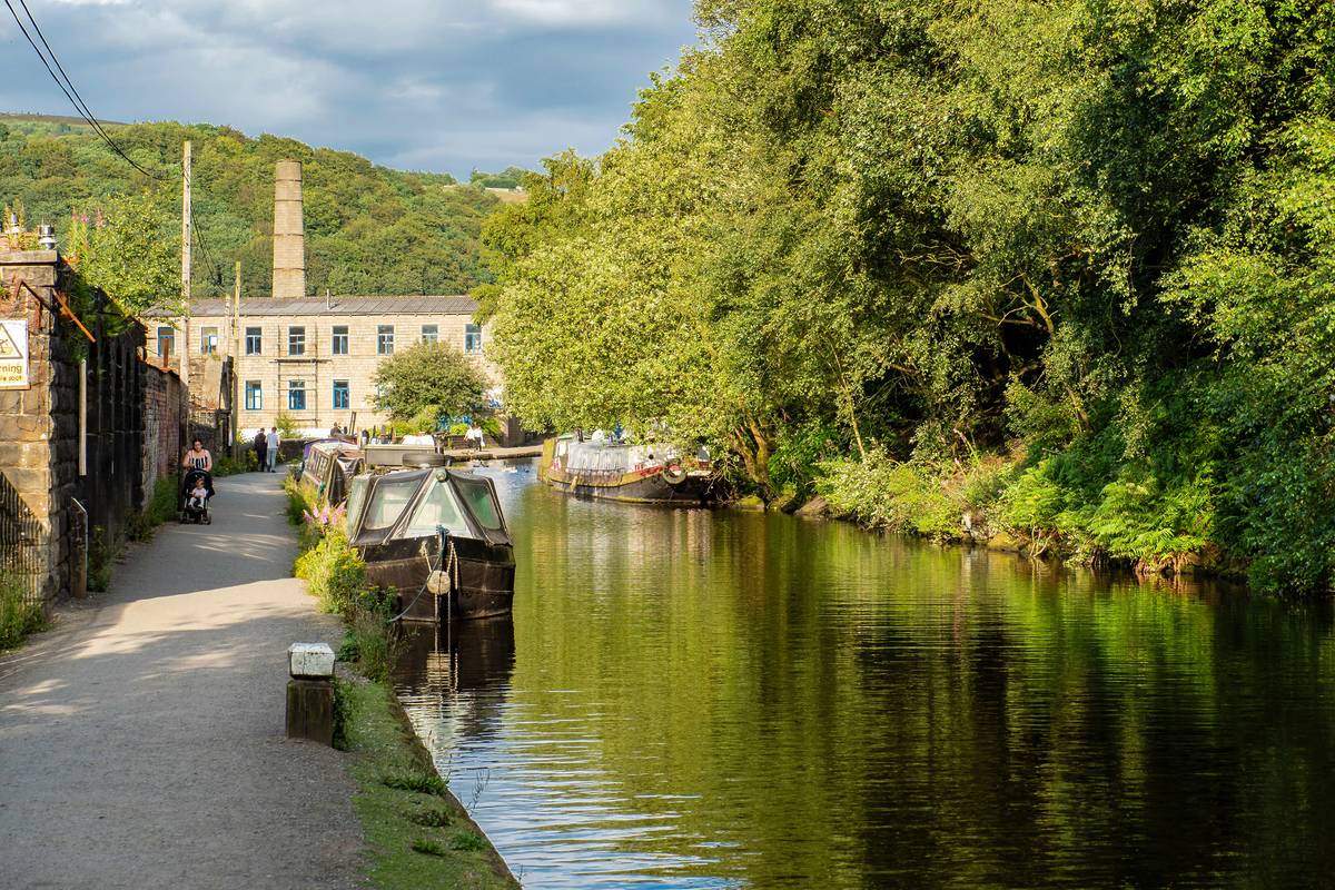 rochdale canal in hebden bridge quaint town with trees and boats