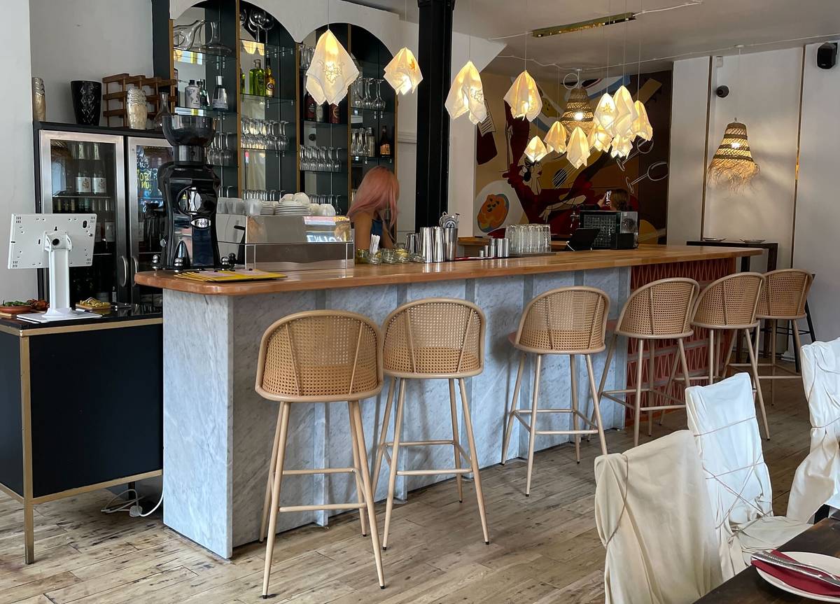 inside maricarmen restaurant in northern quarter, manchester with bar and wicker stools by bar