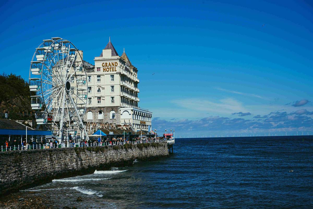 llandudno promenade featuring grand hotel and ferris wheel next to sea