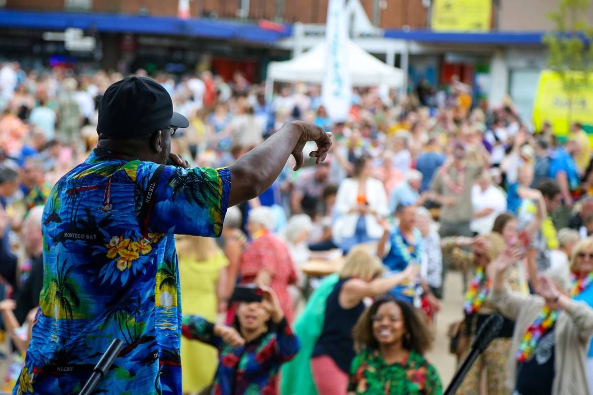 crowd at apple market place in northwich with performer on stage