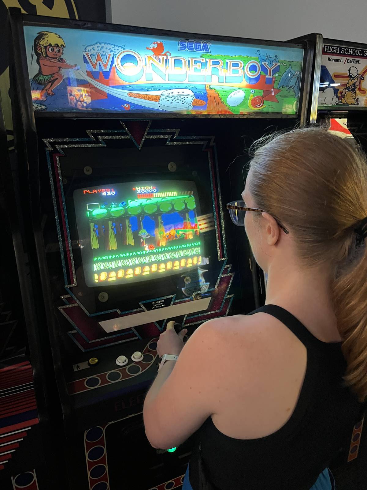 alice playing wonderboy arcade game at arcade club bury