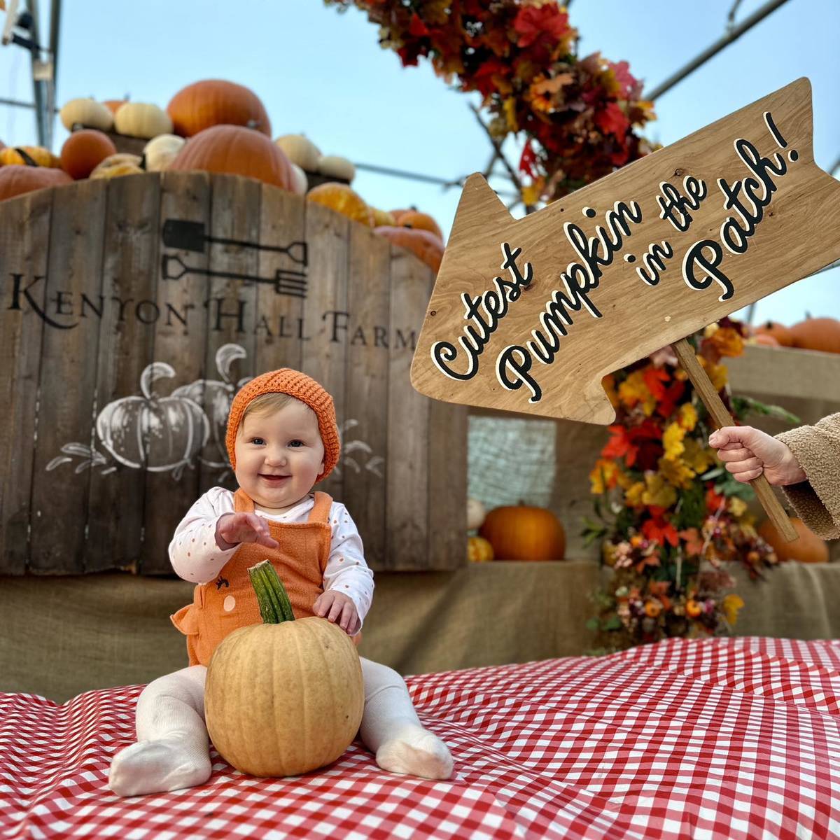 baby on floor with pumpkin