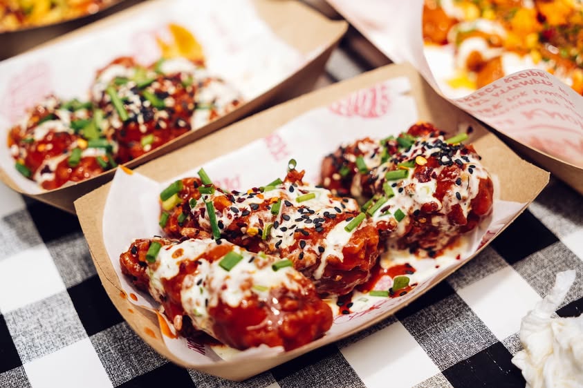 chicken wings in tray slathered with sauce