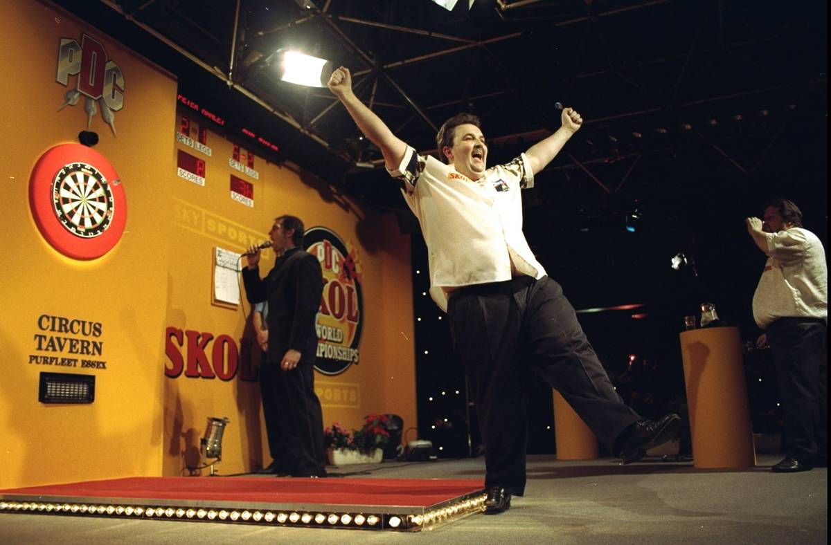 Phil Taylor of England celebrates winning the PDC World Darts Championships in Purfleet in Essex, England