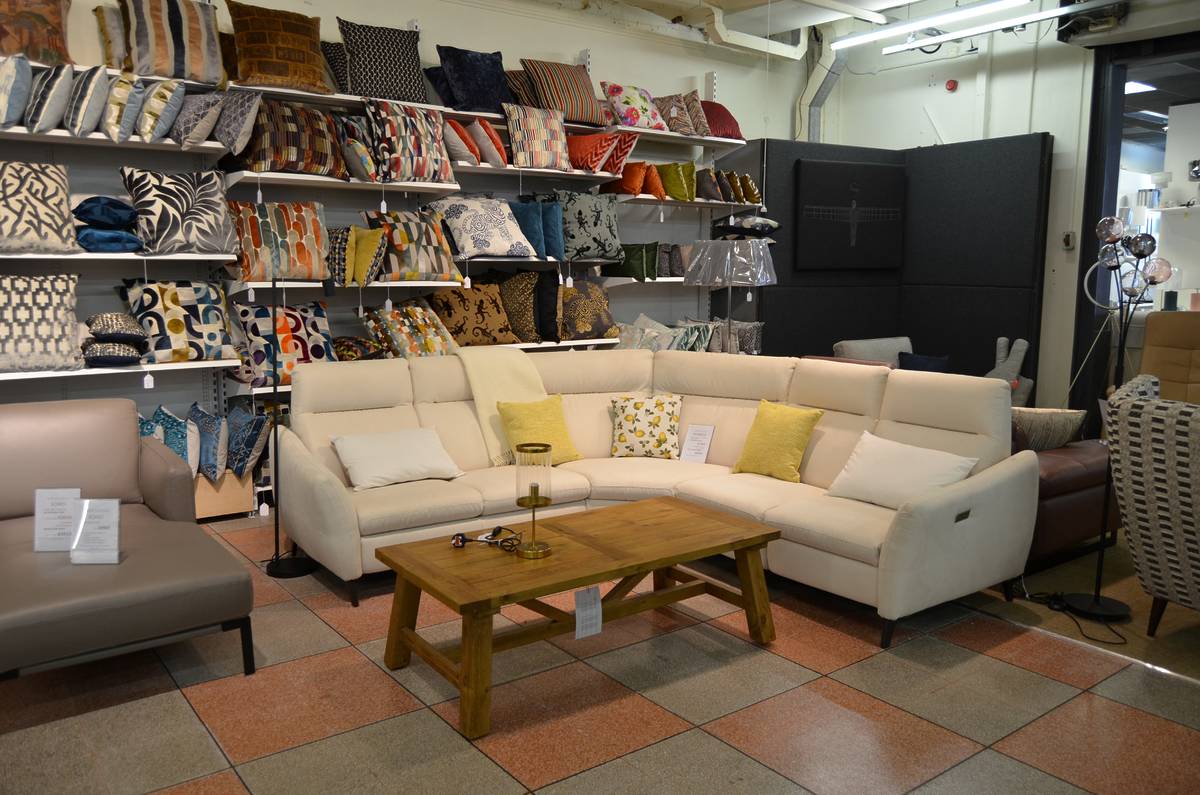 Worthington Brougham Furniture showroom with lounge chairs and sofas shelves of cushions