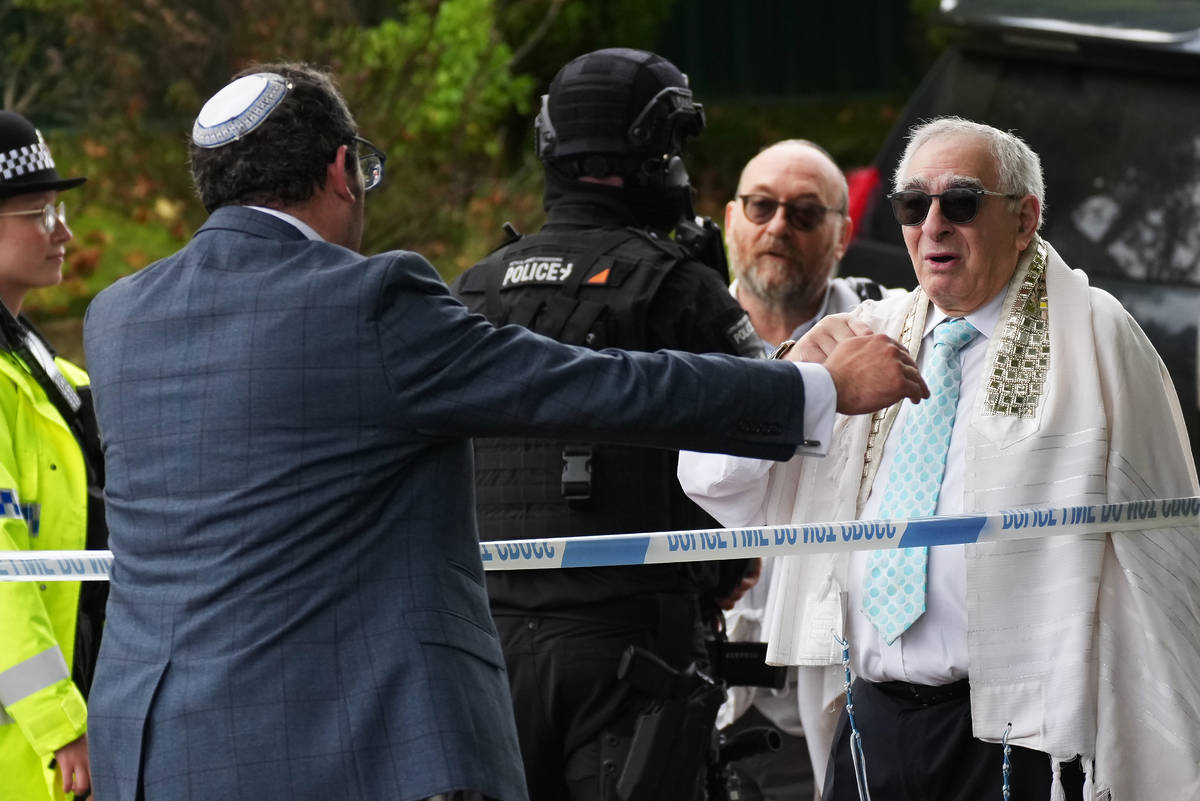 Members of the public and congregants seen as Police and other emergency responders attend the Heaton Park Hebrew Congregation Synagogue, where multiple were injured after stabbing and car attack on Yom Kippur, on October 2, 2025 in the Crumpsall suburb of Manchester, England. Greater Manchester Police said they were called to the scene shortly after 9:30 AM, when a witness said the assailant drove a car at people and then stabbed someone. Police then shot the suspected attacker.