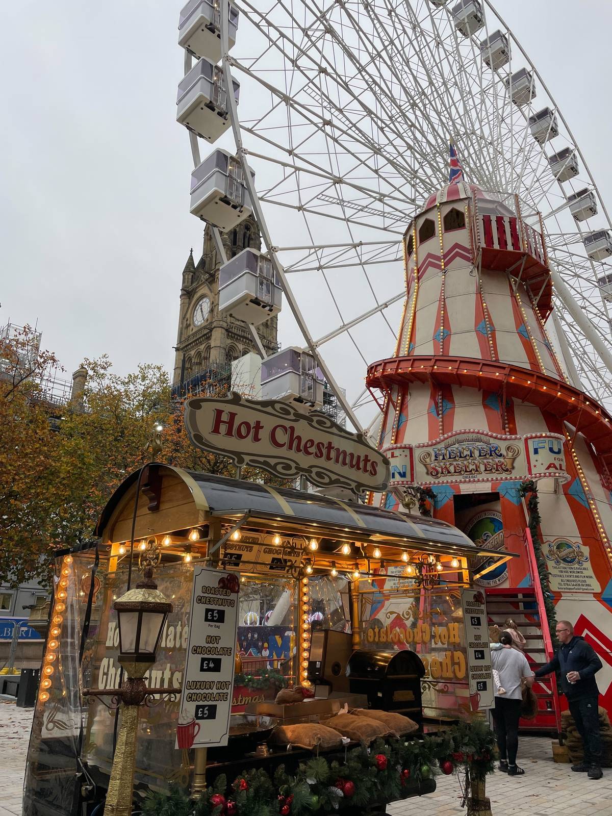 hot chestnuts stand at albert square manchester christmas markets with ferris wheel and helter skelter