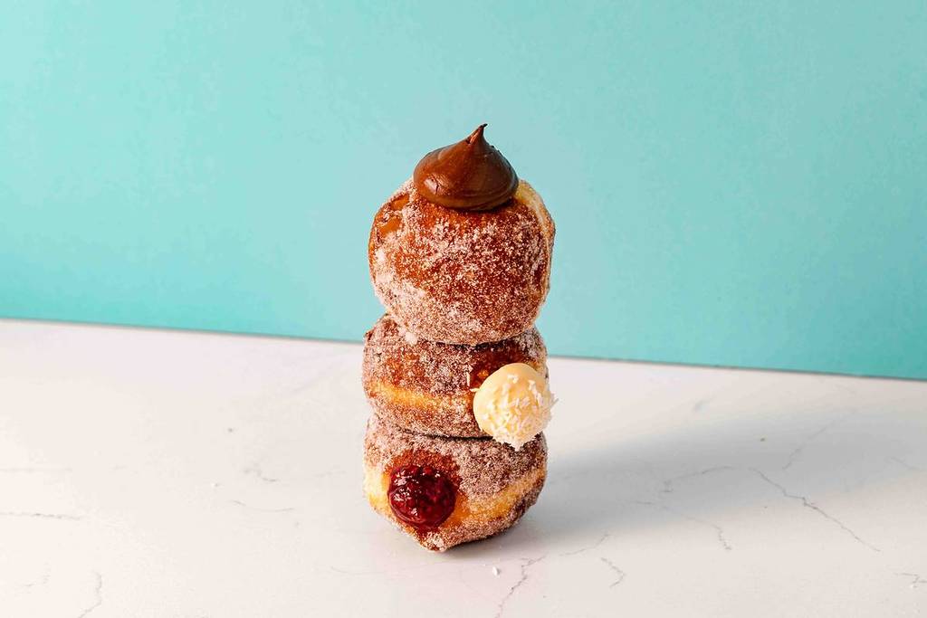 three bread ahead doughnuts stacked up on top of each other