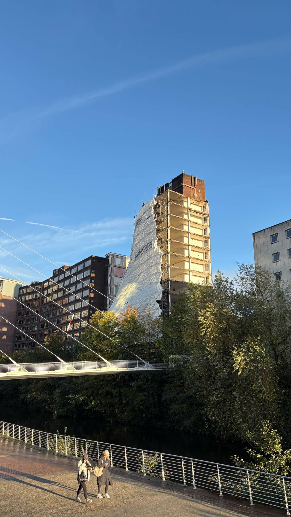view of partially collapsed building in manchester from the lowry bridge over the river irwell