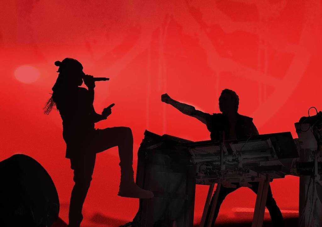 the prodigy on stage with red background