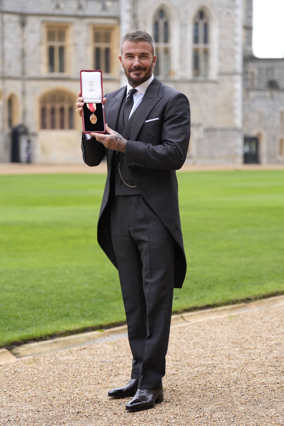 Sir David Beckham poses with his medal after he was made a Knight Bachelor at an investiture ceremony at Windsor Castle on November 4, 2025 in Windsor, England.
