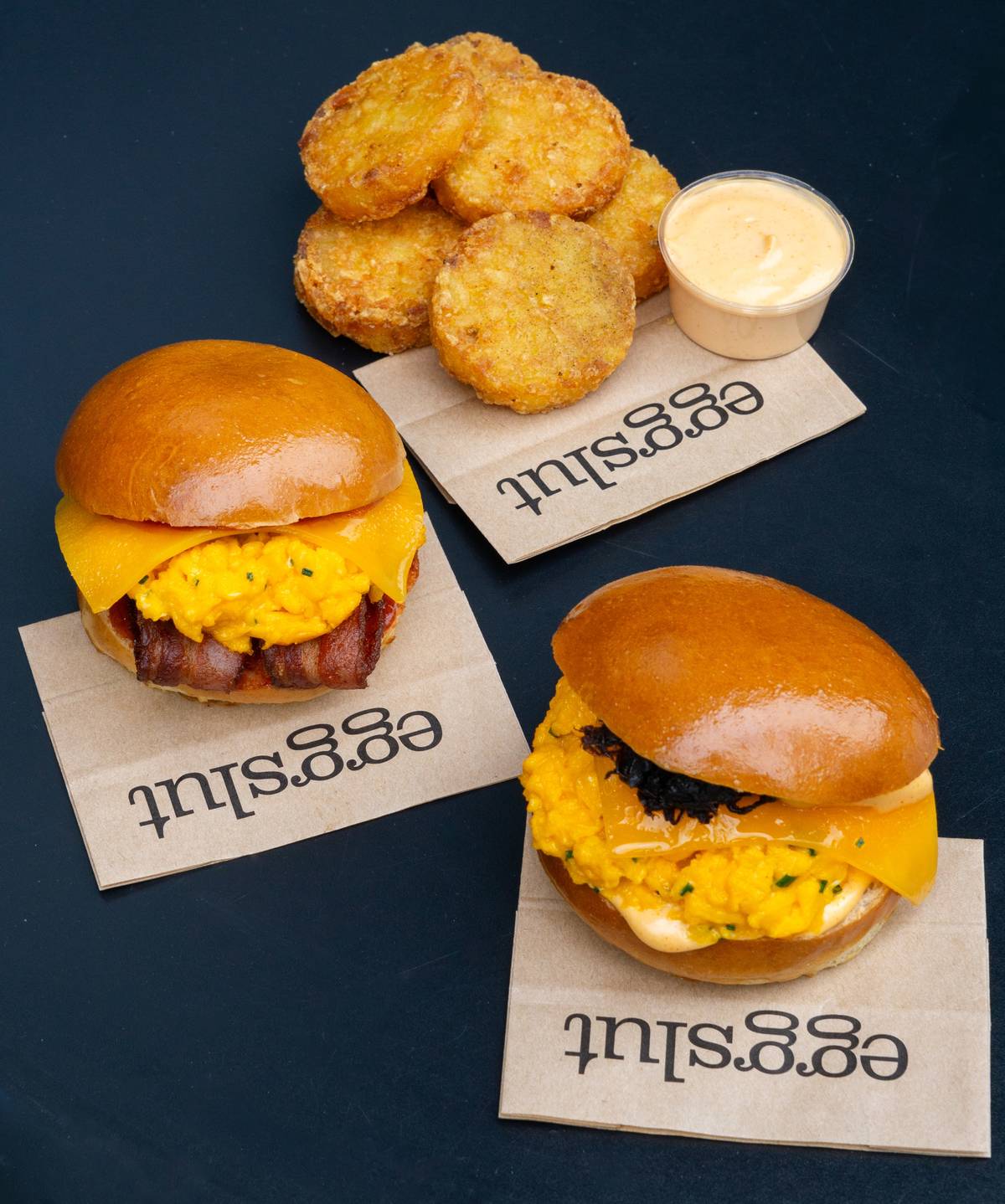 bacon, egg, cheese brioche bun, fairfax brioche bun and hash browns with dip