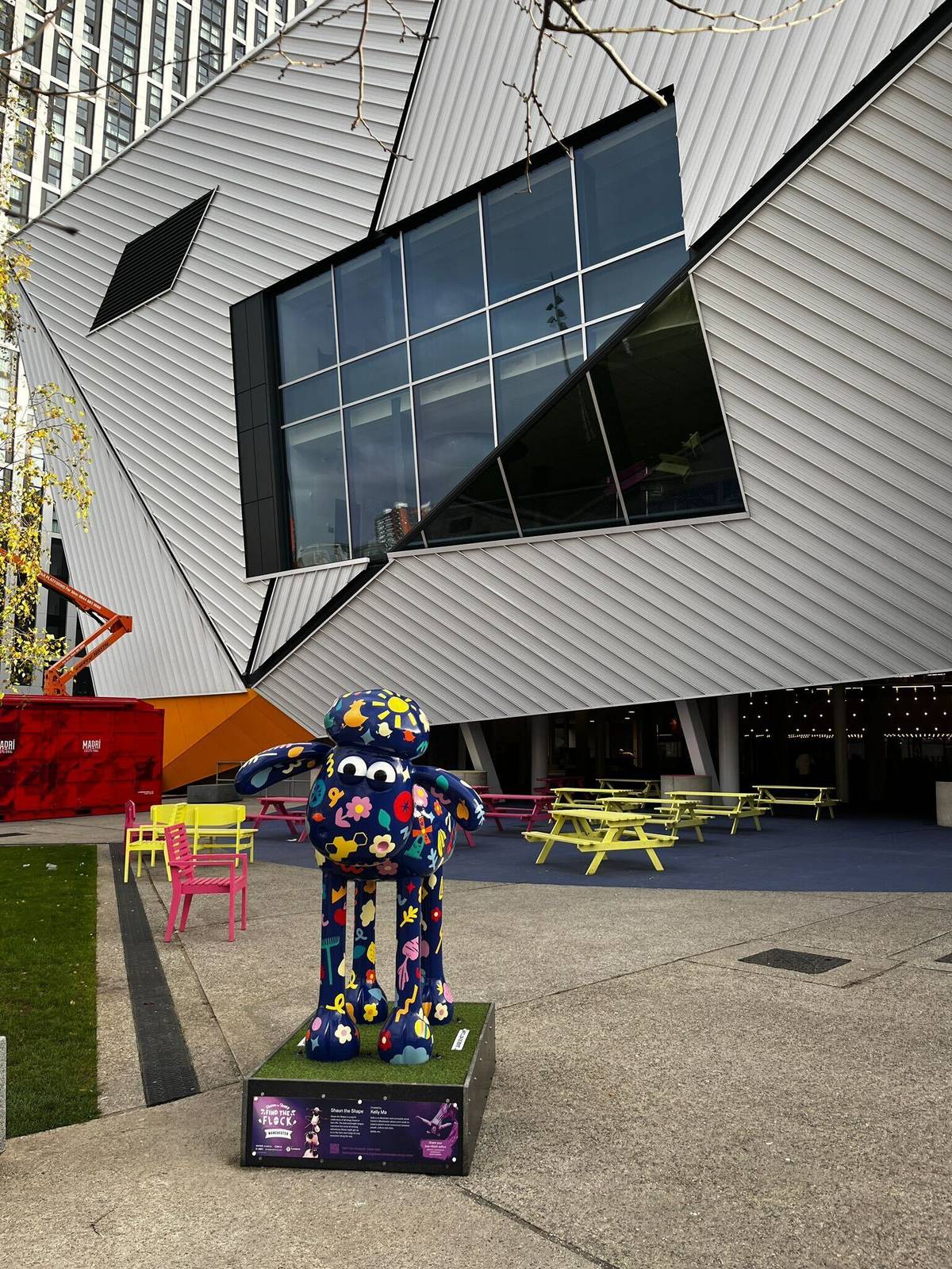 flowery patterned shaun the sheep sculpture outside aviva studios in manchester