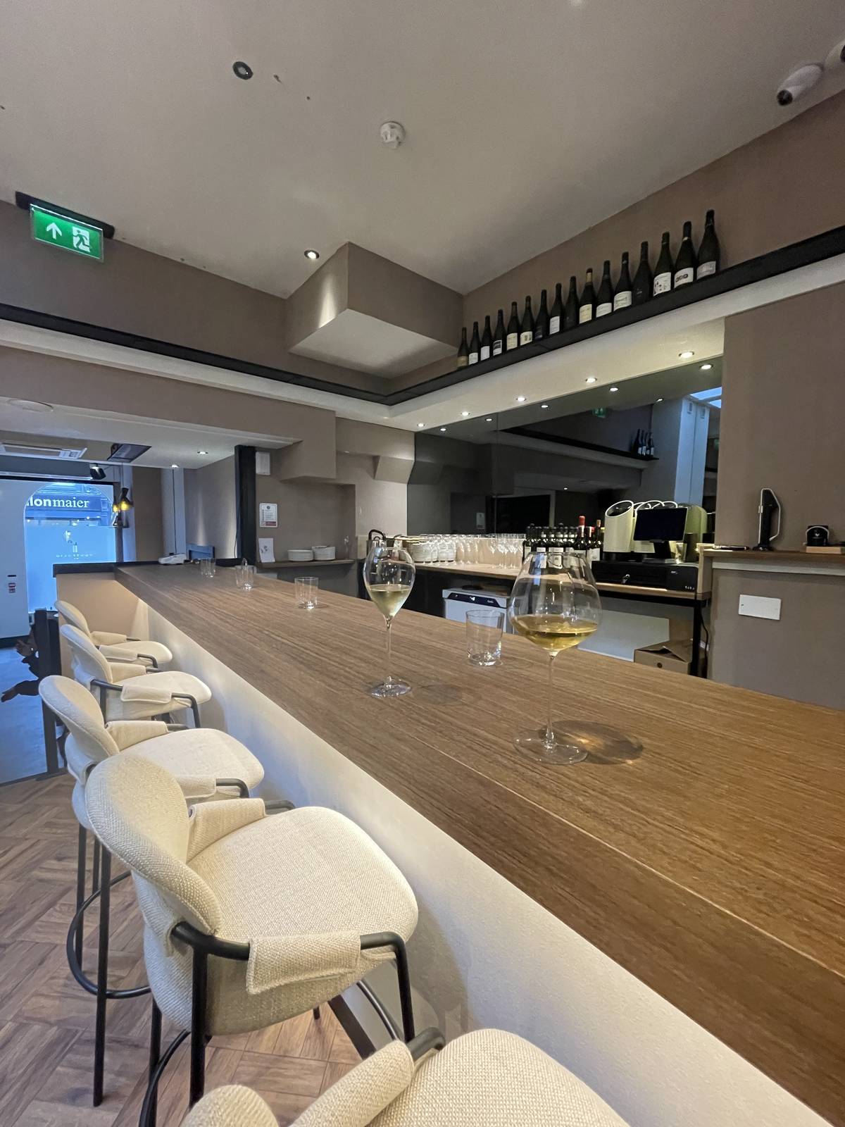 bar area at portfolio with white furnished bar stools and champagne glasses on counter