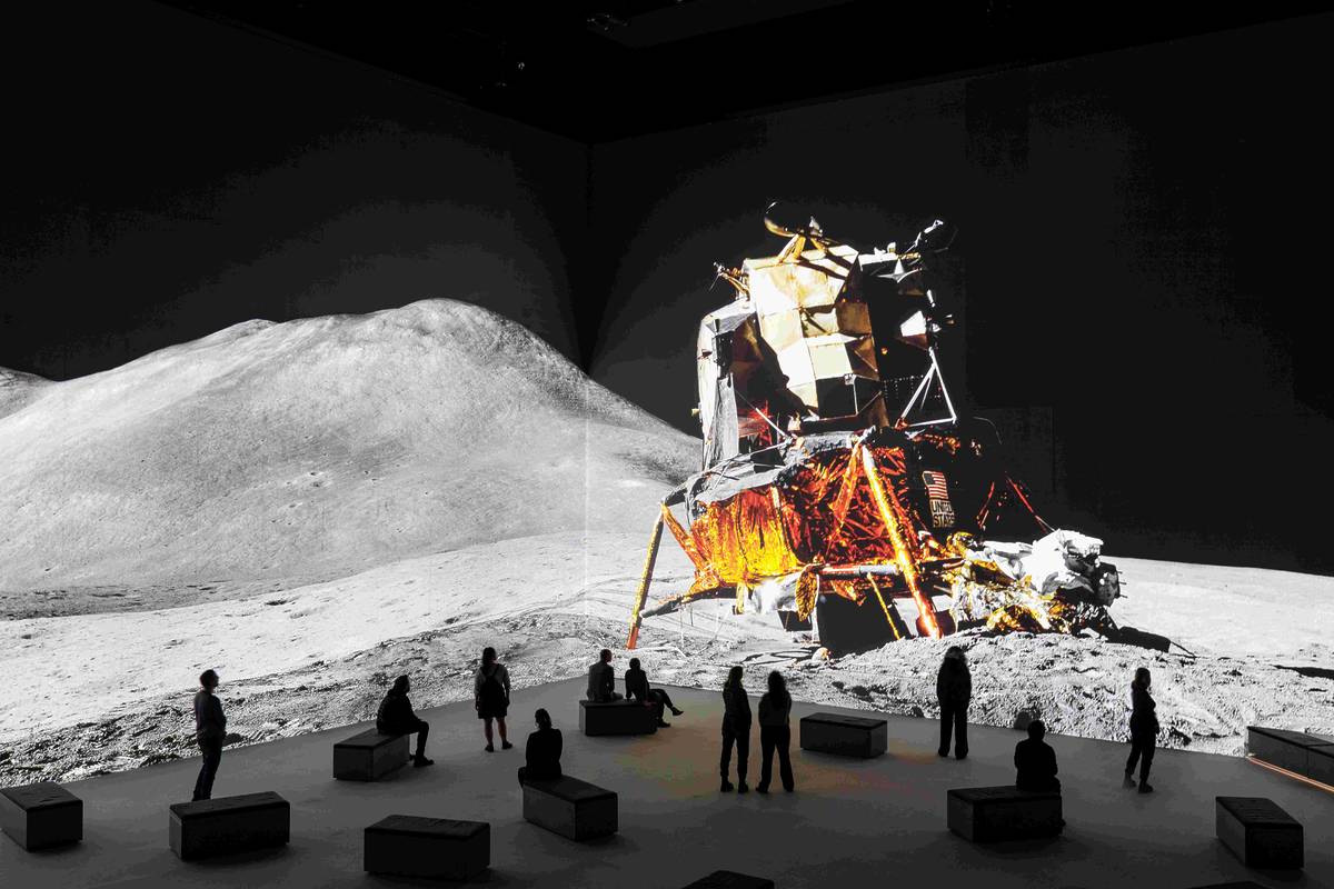 Apollo landing on the moon projected onto wall at The Moonwalkers A journey With Tom Hanks exhibition