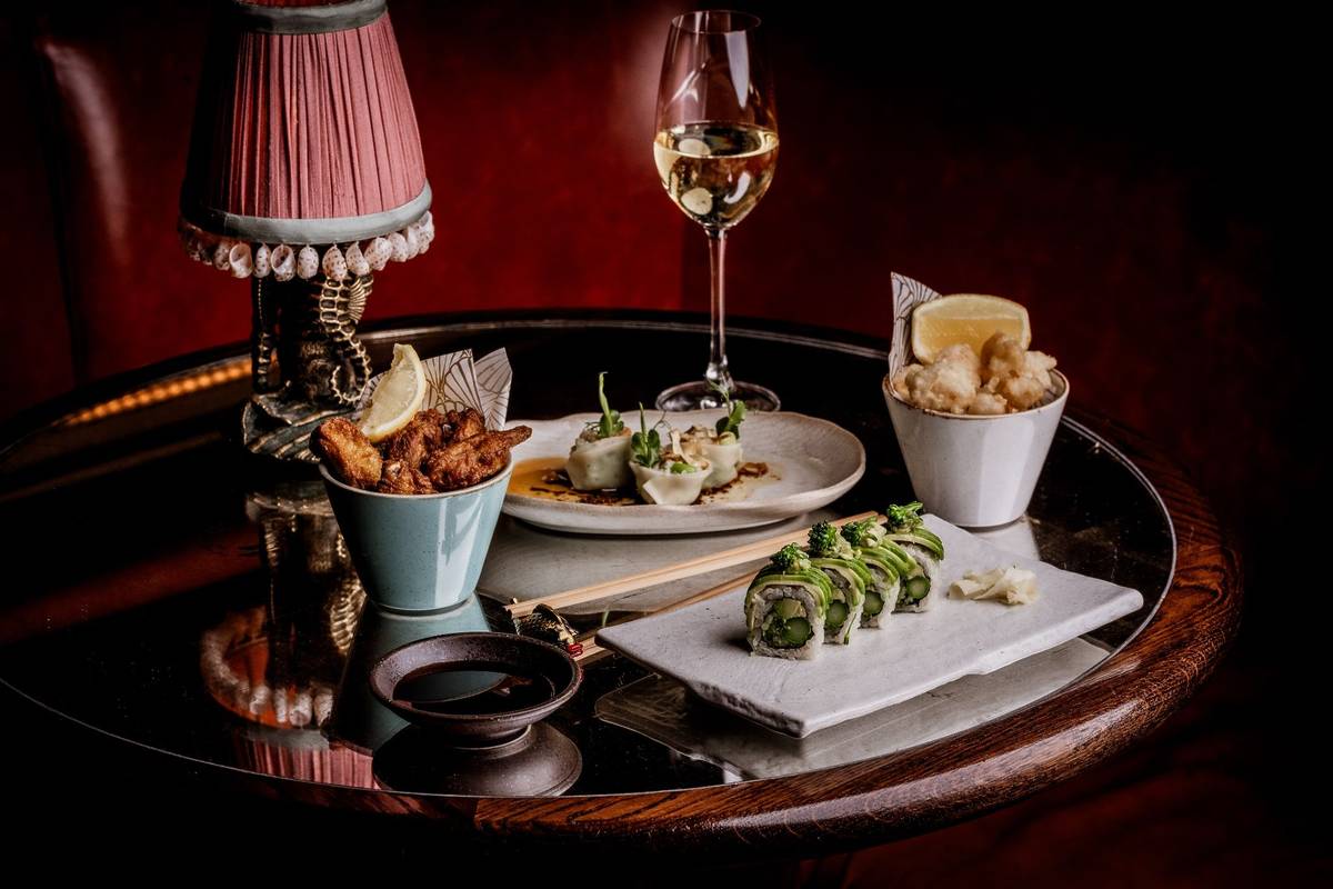 sxy fish chamapgen and snacks and sushi next to lamp