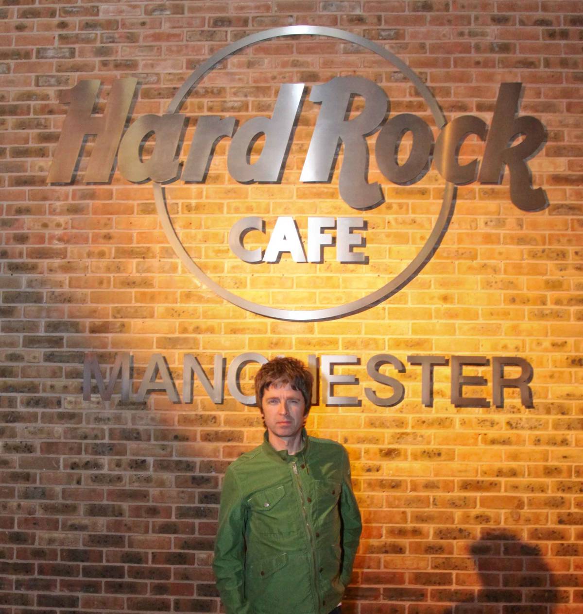 noel gallagher stood in front of hard rock cafe manchester