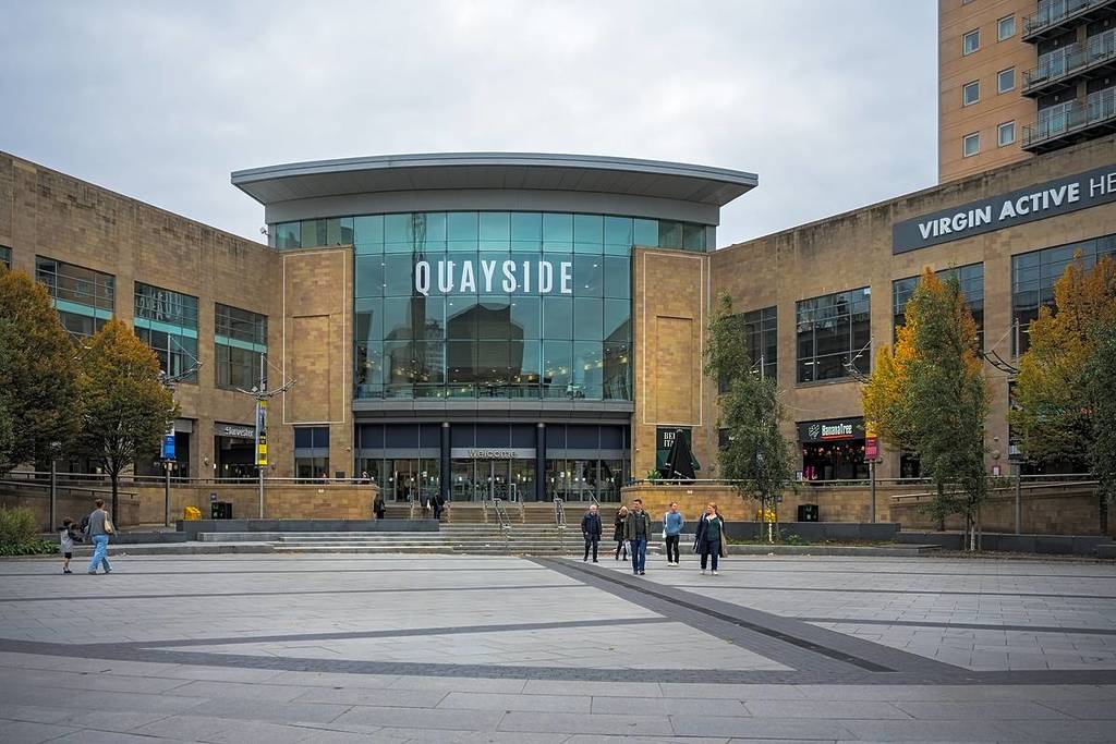 Salford, Manchester, UK, 18 October 2025: Quayside Salford modern shopping center entrance with people walking by on an overcast day.