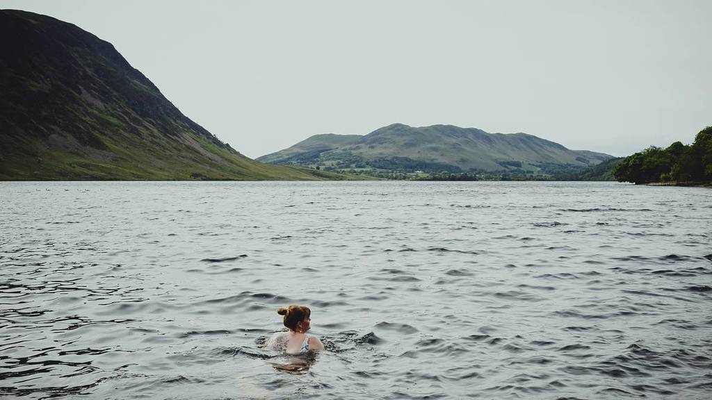 person swimming in a loch