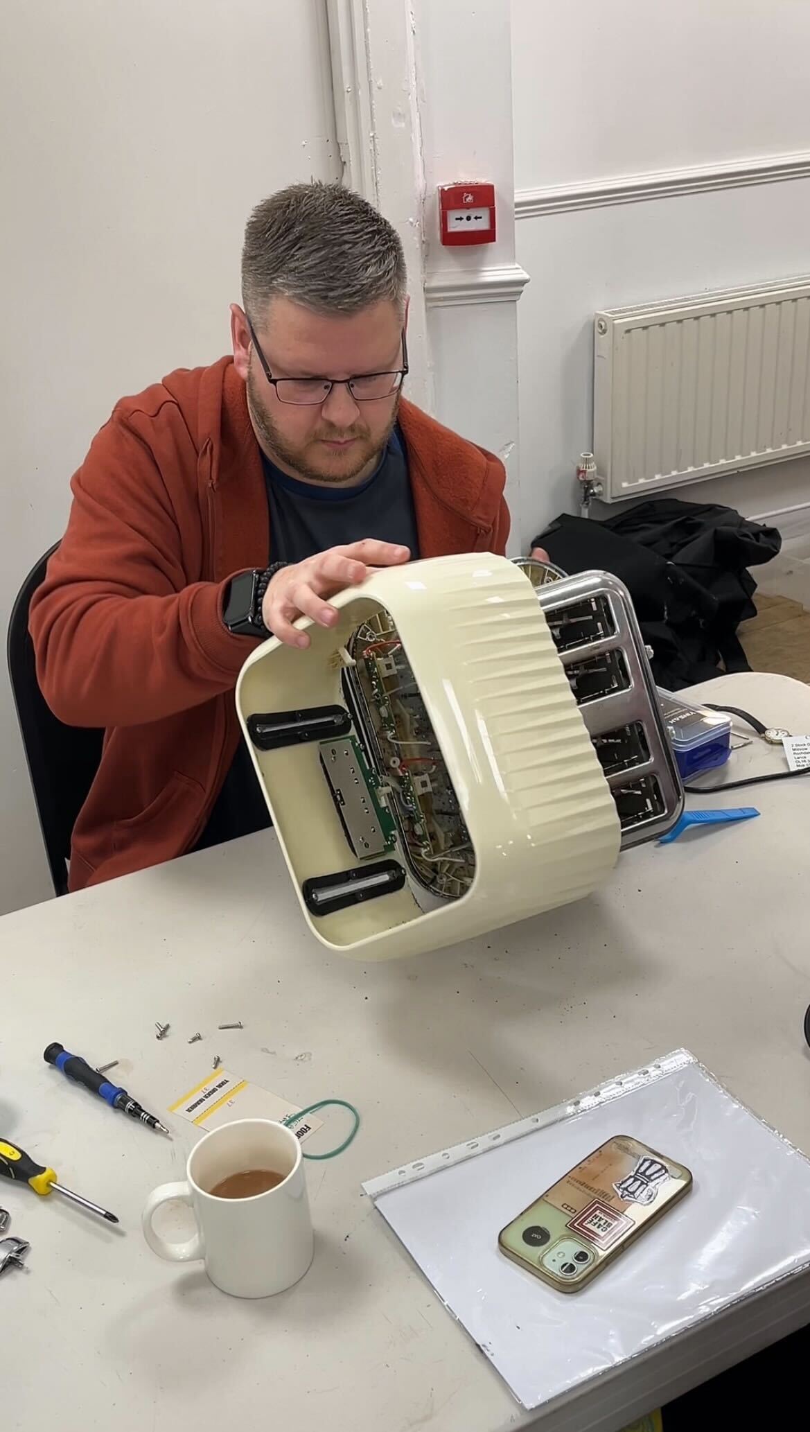 man fixing toaster at NEPHRA Repair Cafe in Manchester