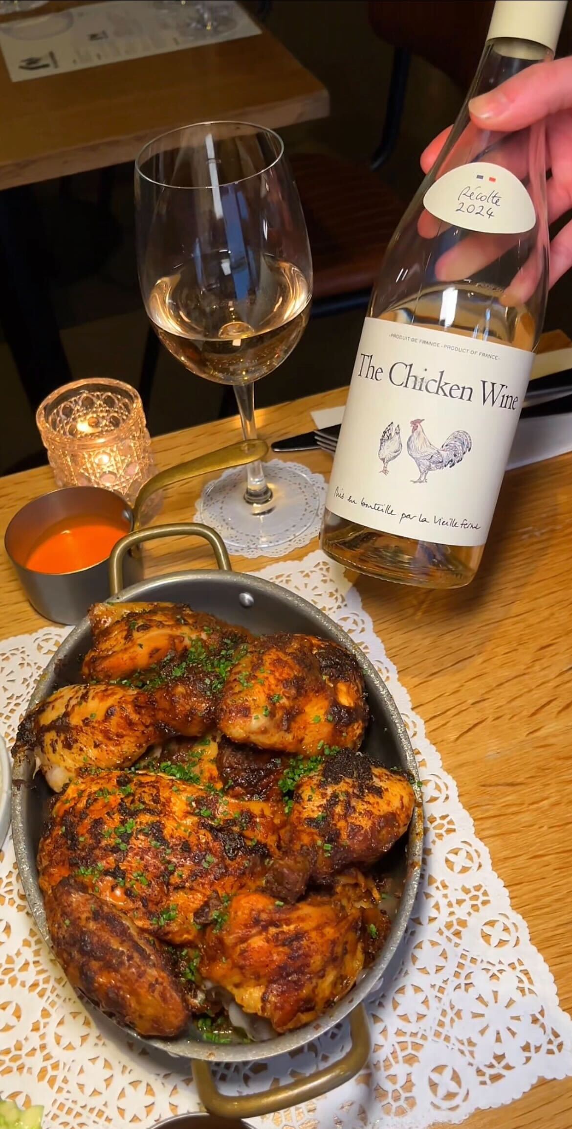 bottle of chicken wine next to chicken at le coq boutique