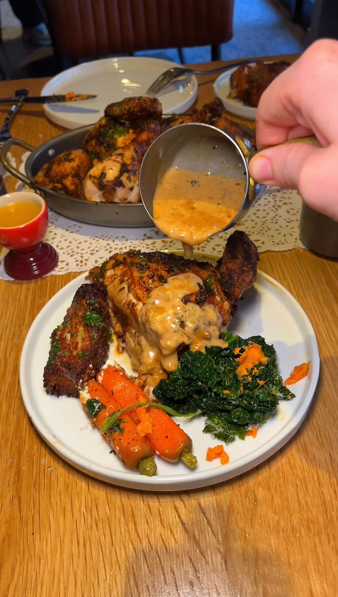 chicken jus being poured over roast chicken