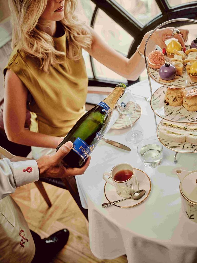 woman being poured champagne at the rex hotel gotham afternoon tea