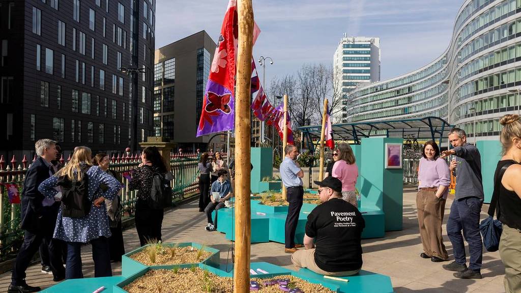 people sat in manchester piccadilly station sanctuary garden