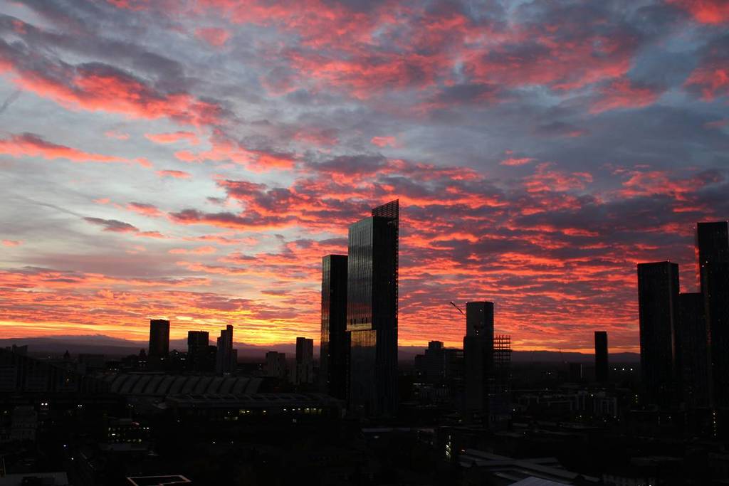 sunset over manchester skyscrapers with pink skies