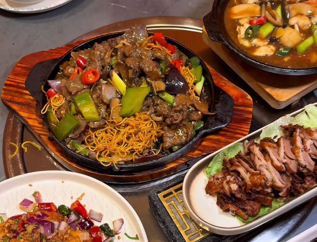 selection of dishes at k-cuisine including beef with noodles and crispy duck