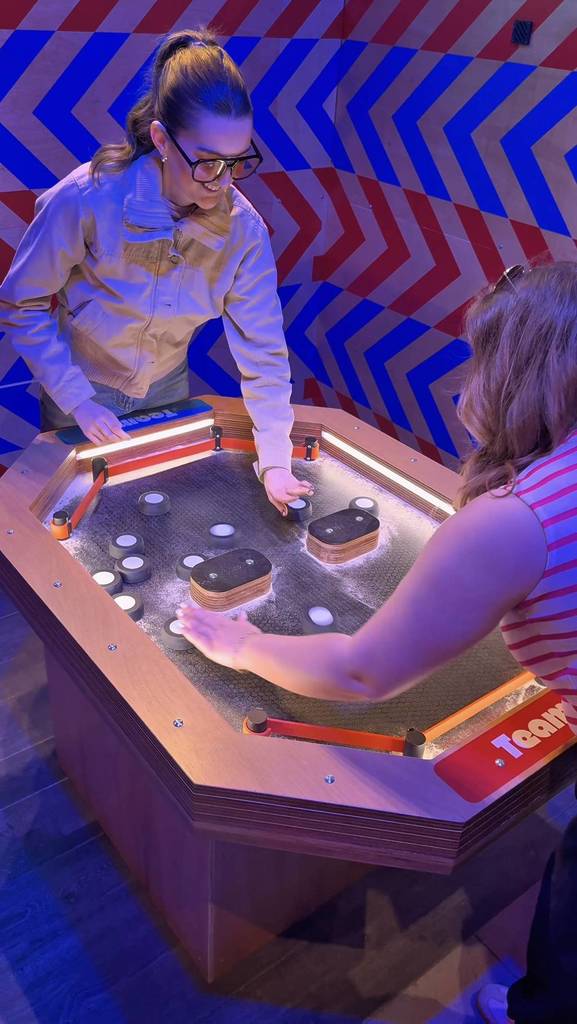 people playing pinball game