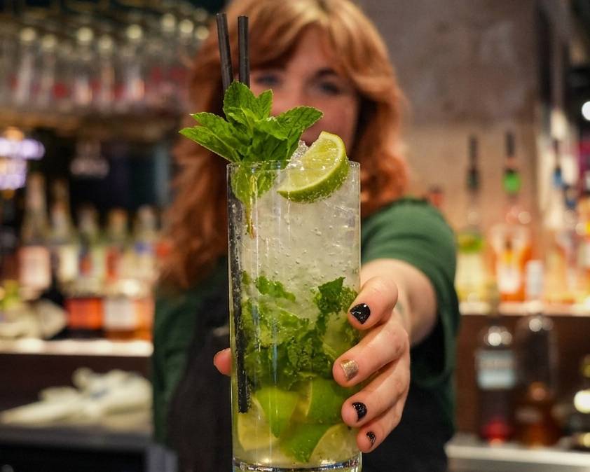 women holding a nojito cocktail at motley bar in manchester