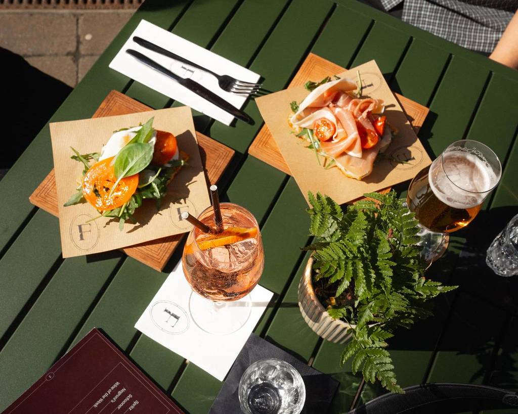 paninos, spritx and beer on table on federico wine bar terrace